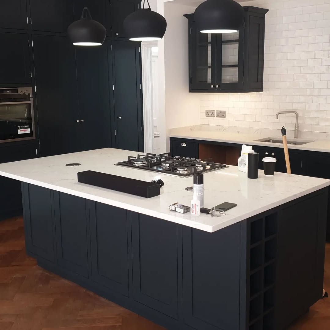 Kitchen after — dark navy painted cabinets