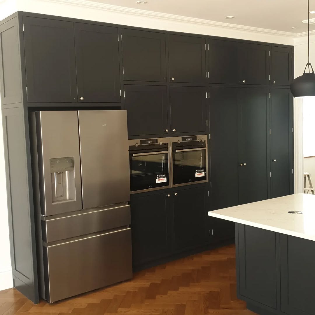 Luxury dark navy kitchen with pendant lights